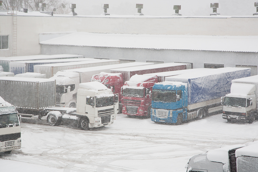 Trucks Loading At Warehouse And Transport Terminal. Inclement holiday weather