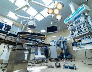 Medical devices and industrial lamps in surgery room of modern hospital.
