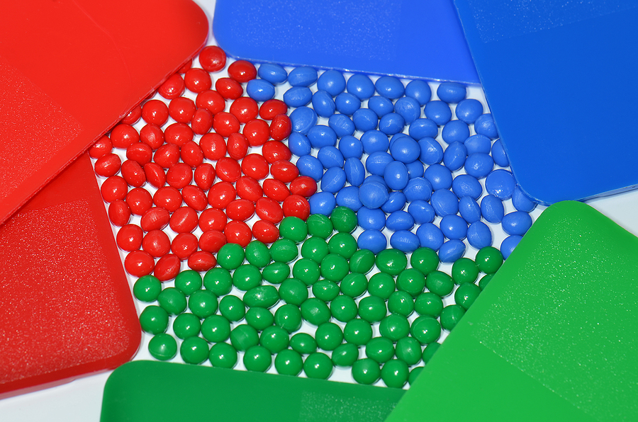 color samples with corresponding polymer resins in red, green, and blue colors; color strength