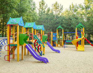 Colorful children playground activities in public park. Safe modern children's playground made with outdoor plastic types..