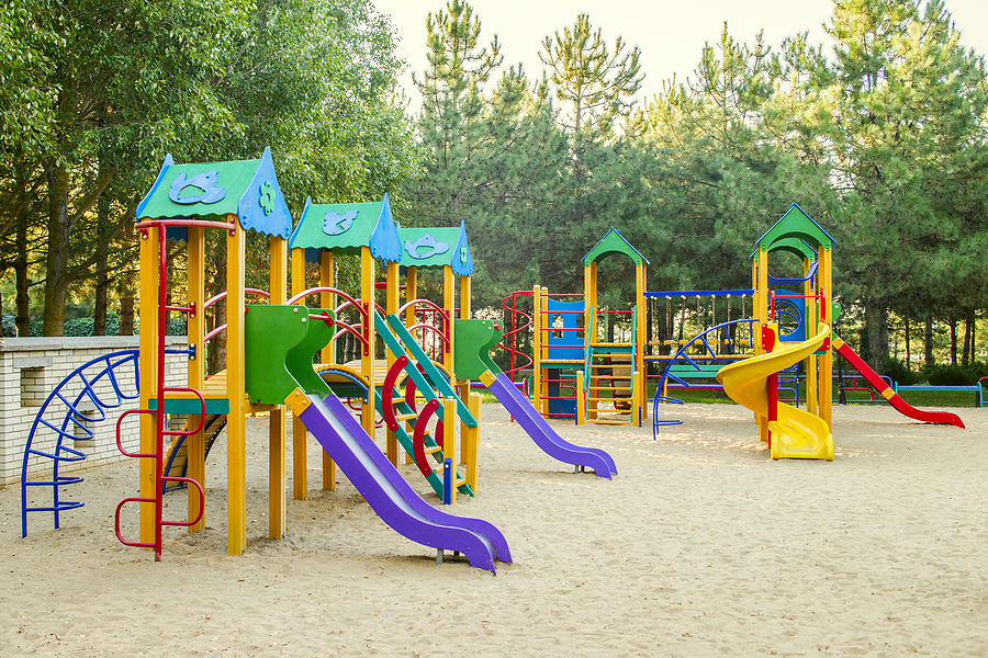 Colorful children playground activities in public park. Safe modern children's playground made with outdoor plastic types..